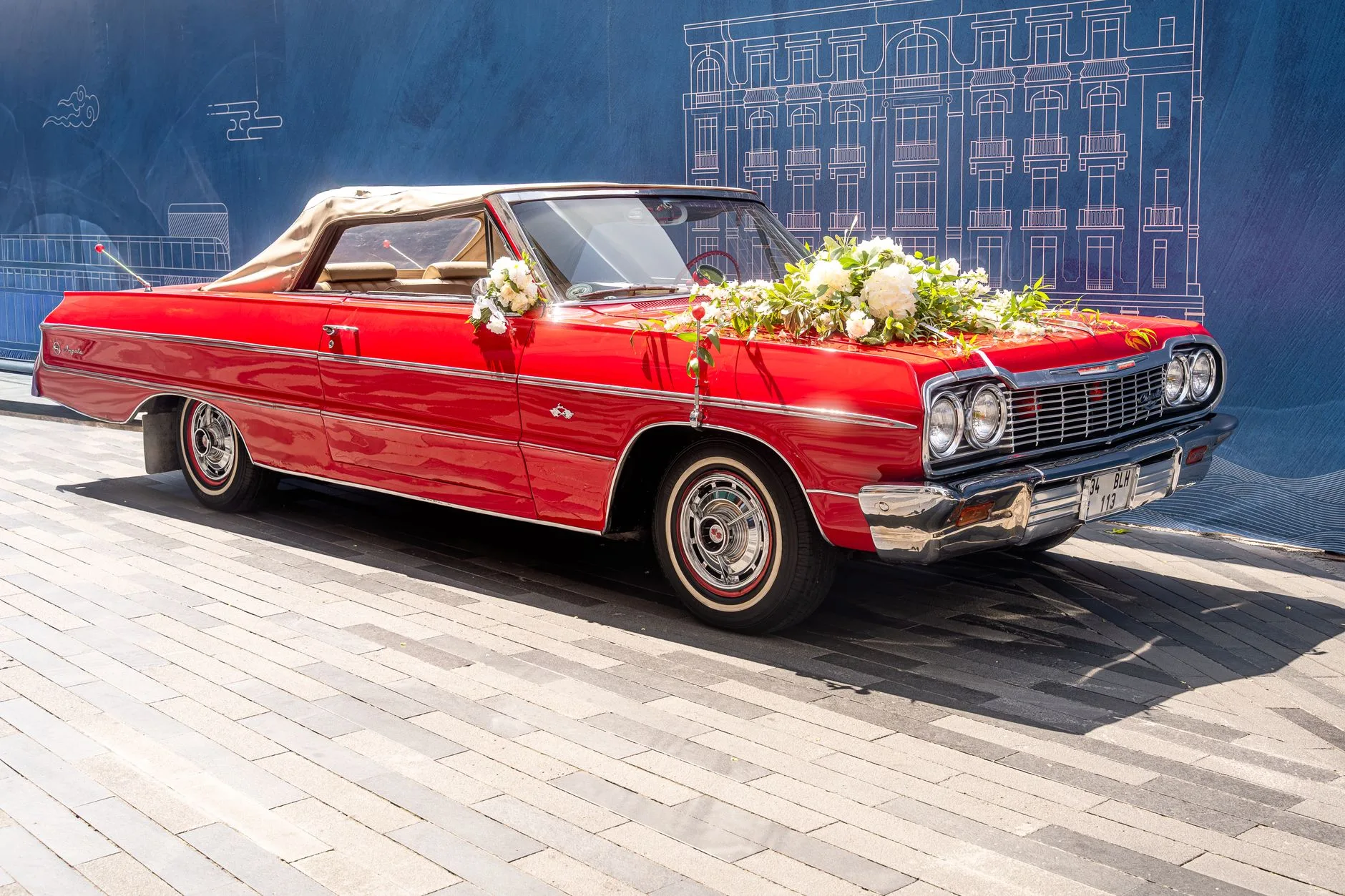 Open-top sports car ready for a bride and groom's departure.